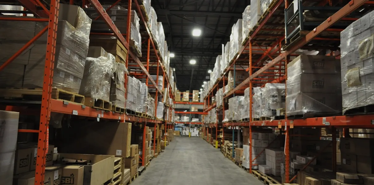 Warehouse aisle with tall shelves and boxes