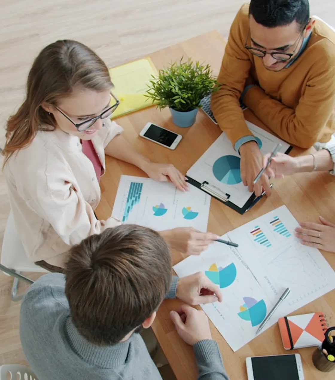 Team reviewing charts and reports at a table