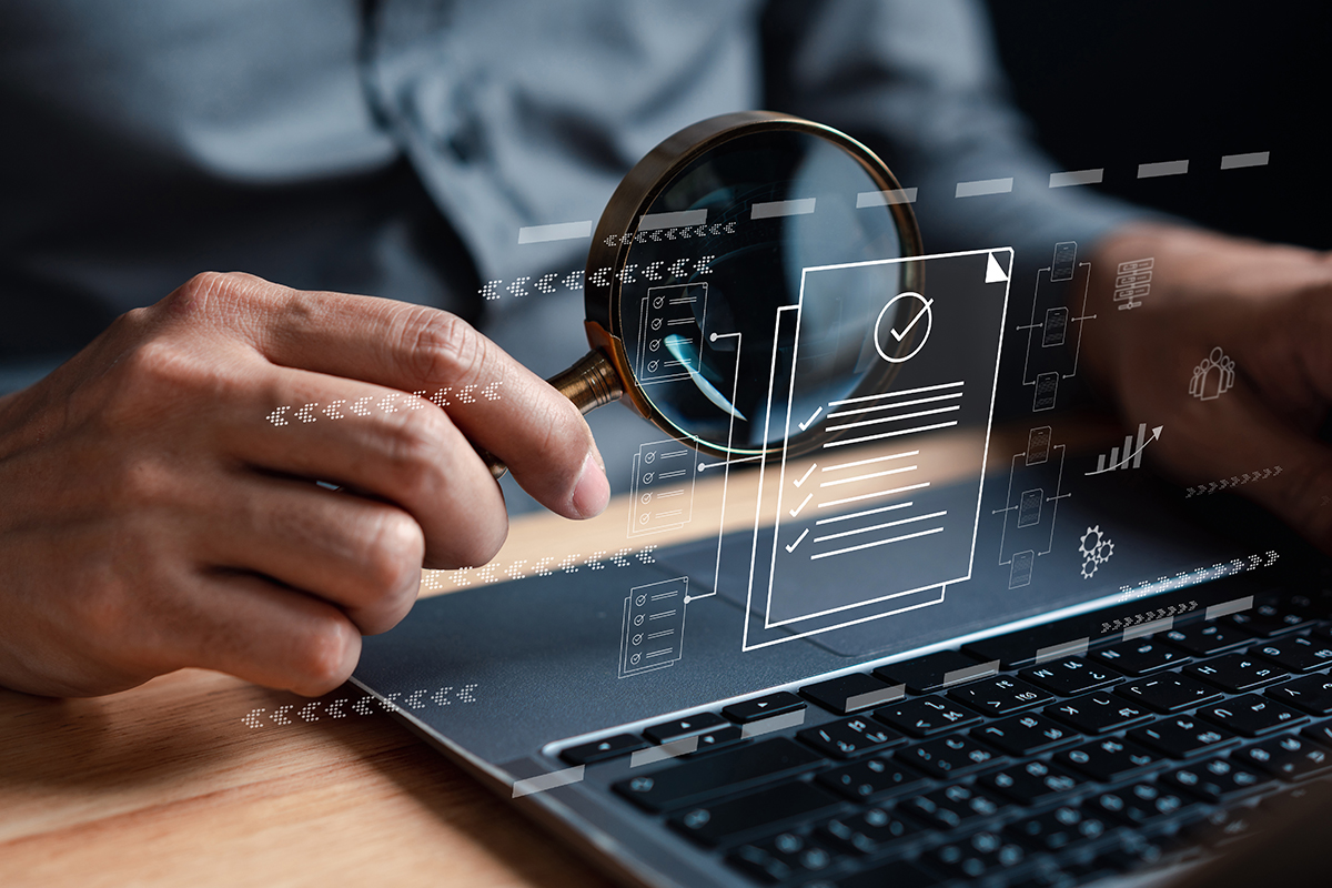 Magnifying glass examining digital checklist on laptop screen