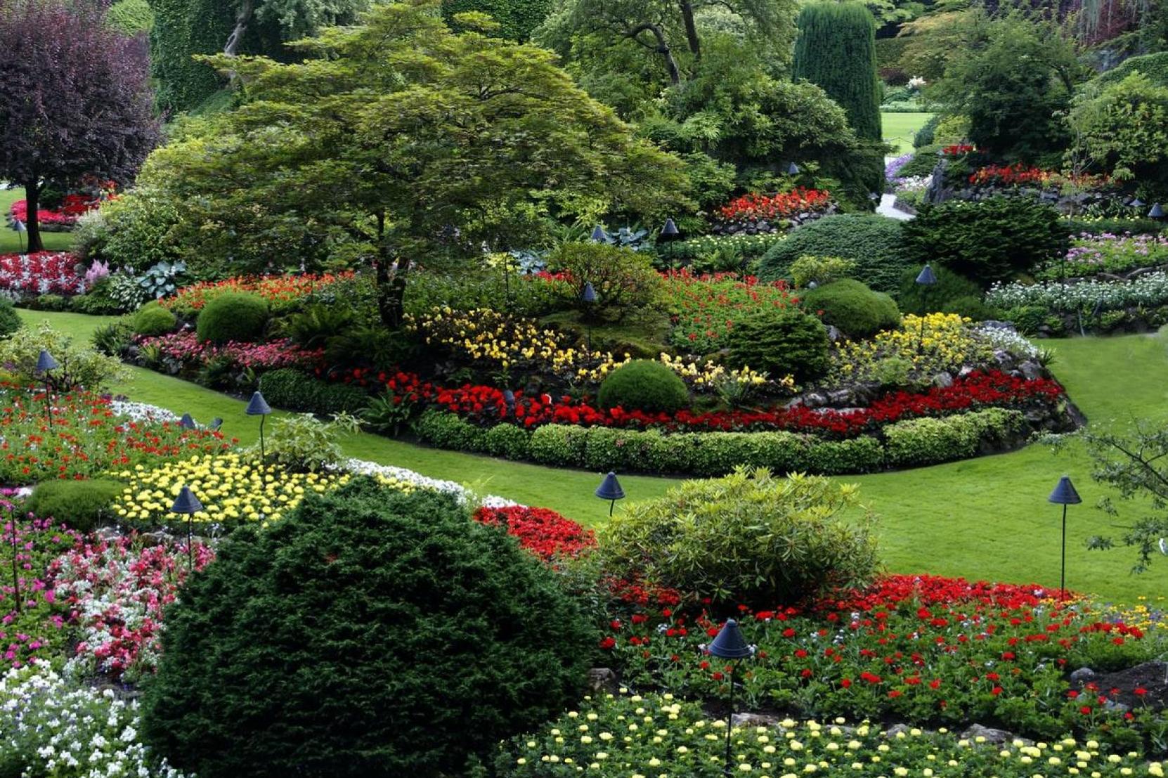 Meticulously landscaped garden with colorful flower beds and sculpted greenery
