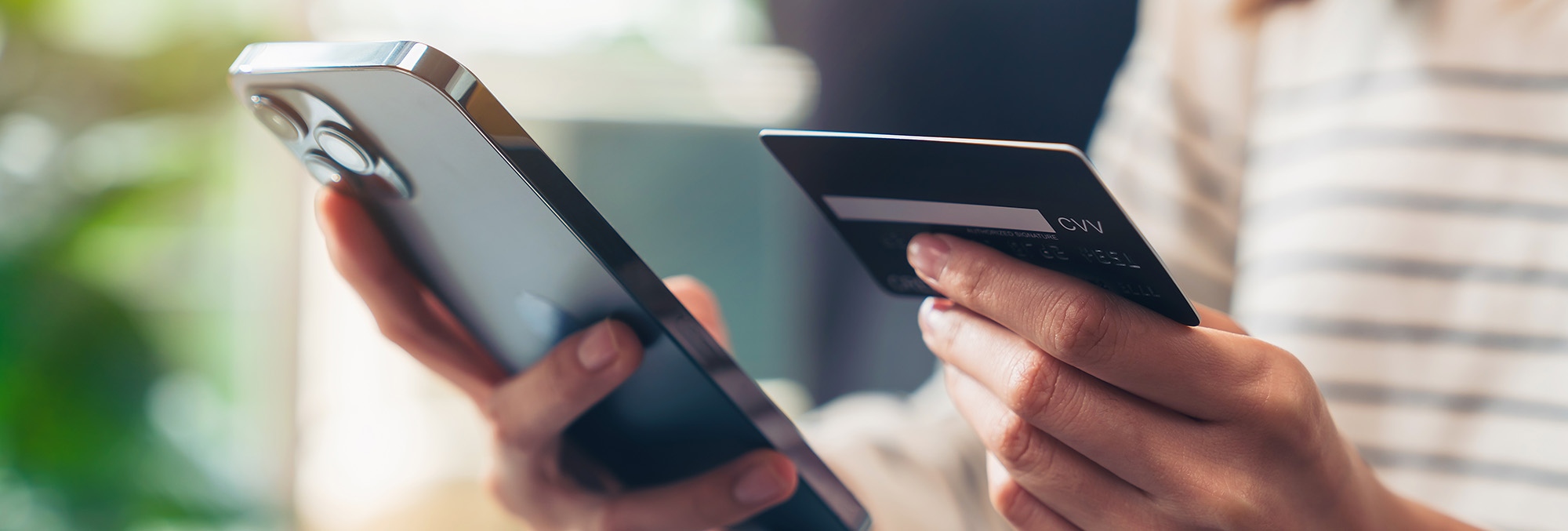 Hands holding smartphone and credit card for online mobile payment