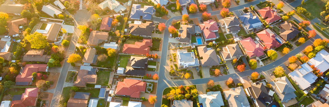 Aerial view of suburban neighborhood with colorful autumn trees