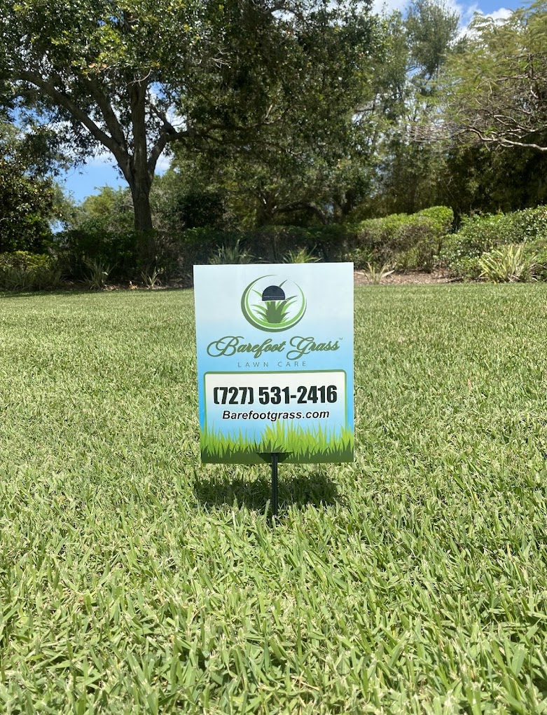 Barefoot Grass Lawn Care sign placed in a lush green lawn