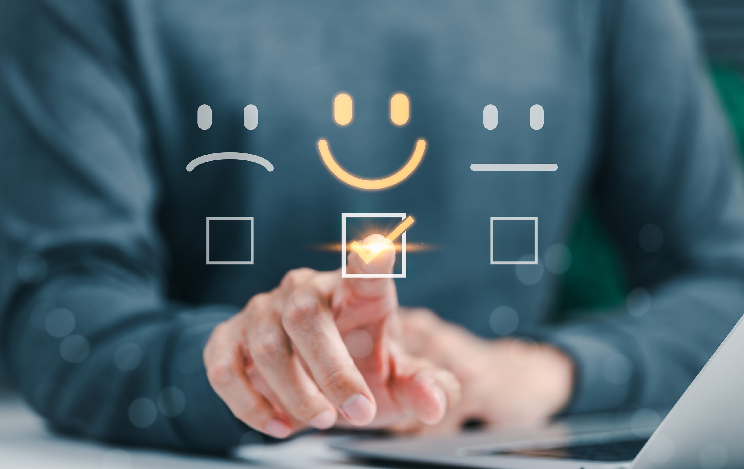 Person selecting happy face in customer satisfaction survey online