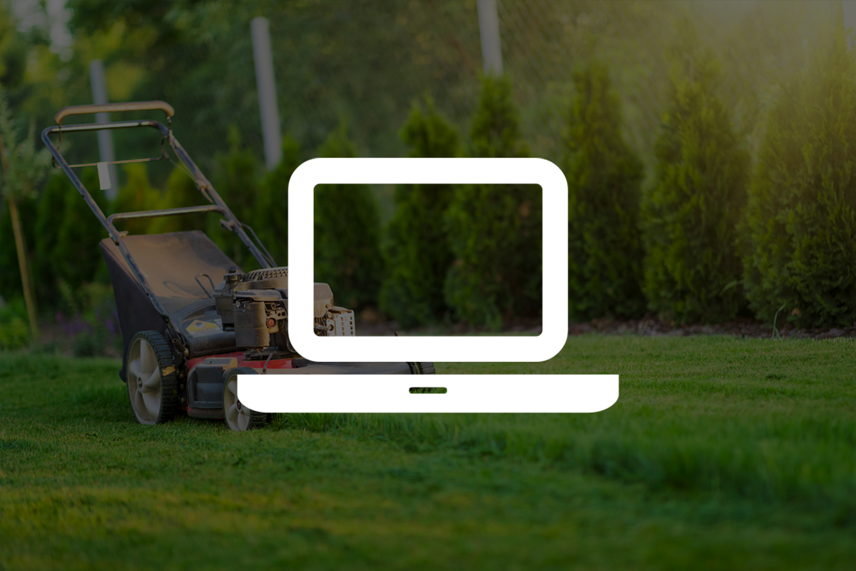 Lawn mower on green grass with laptop icon overlay