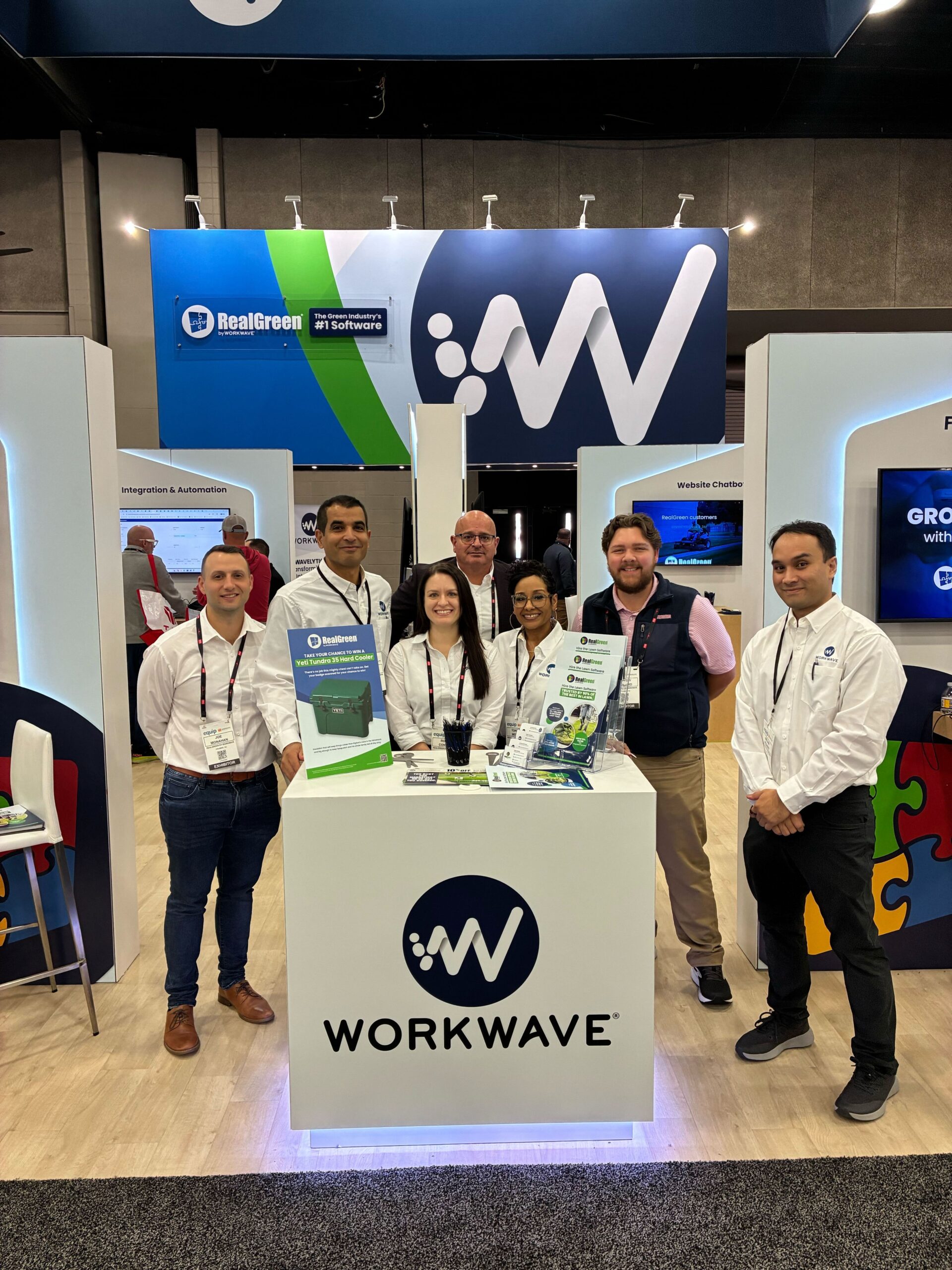 WorkWave team at conference booth showcasing green and blue software solutions