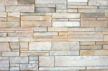 Decorative stone wall with layered rectangular beige and gray tiles