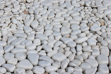 Smooth white and gray rounded pebbles tightly packed together