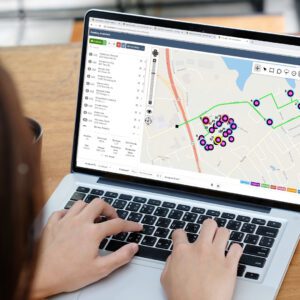 Laptop screen displaying digital map with location pins and tracking route