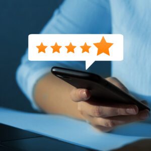 Hand holding smartphone with five-star rating review bubble