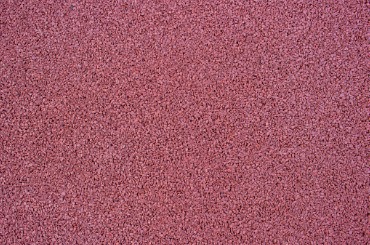 Textured burgundy or maroon speckled background with grainy surface