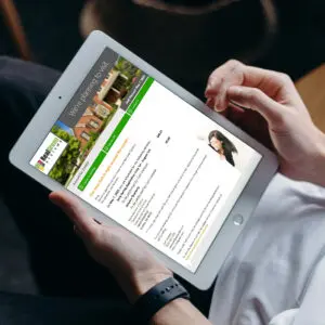 Person reading digital document on tablet with property listing details