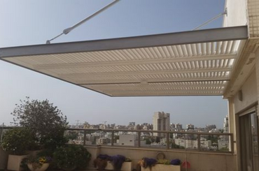 Modern metal pergola on rooftop terrace with city skyline view
