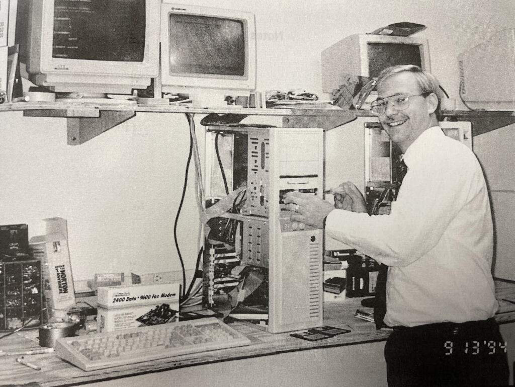 Scientist working with vintage computers and technology in black and white