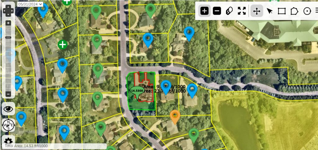 Aerial property map with yellow lot lines, green and blue location markers