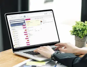 Laptop displaying analytics dashboard with hands typing on keyboard