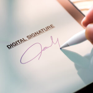 Hand creating digital signature with stylus on electronic document
