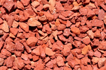 Red crushed stones or gravel covering a surface
