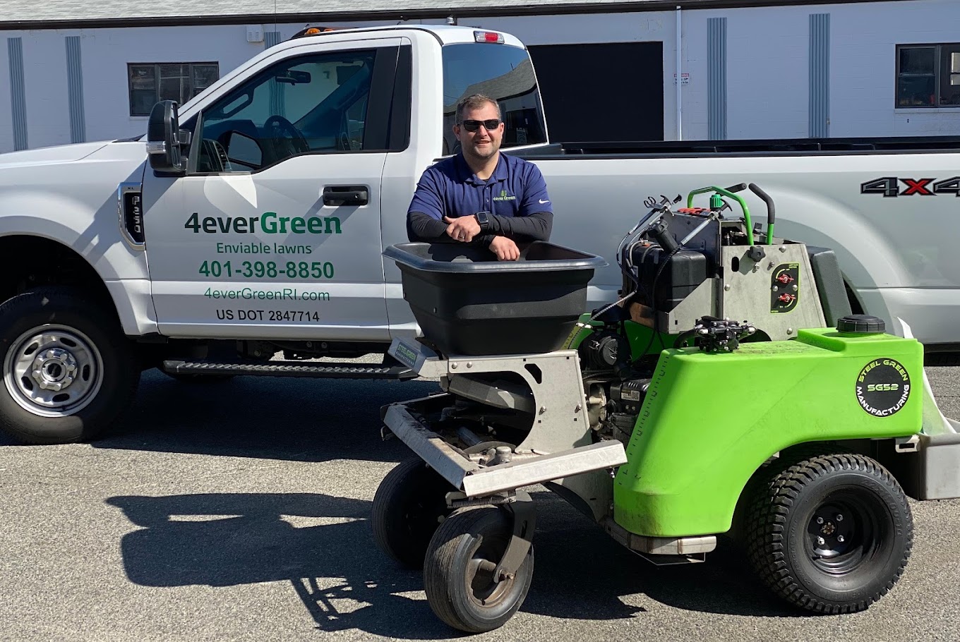 4everGreen lawn care truck and employee with professional landscaping equipment