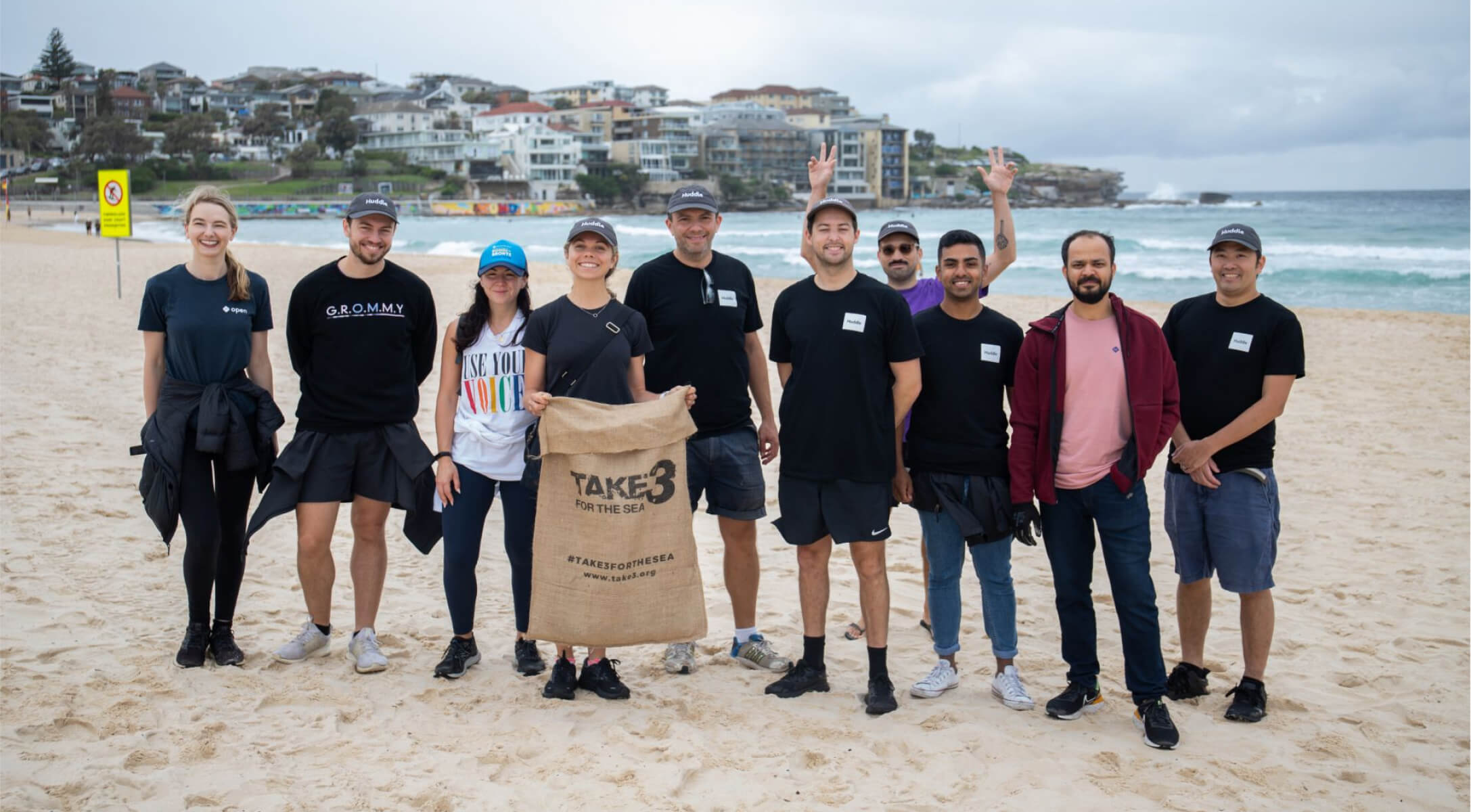 The open team completing a beach clean up as part of take 3 for the sea