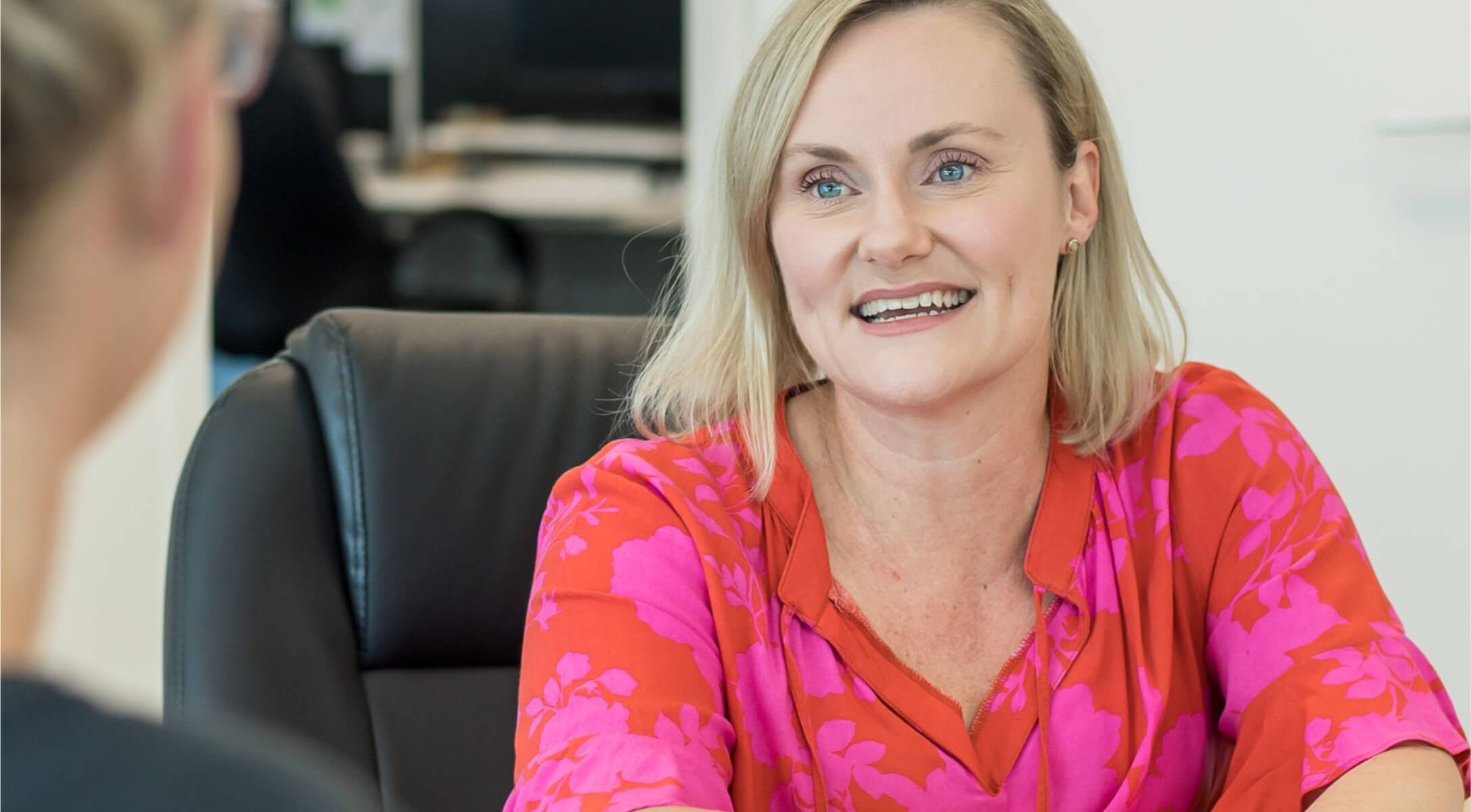 Woman talking to team member