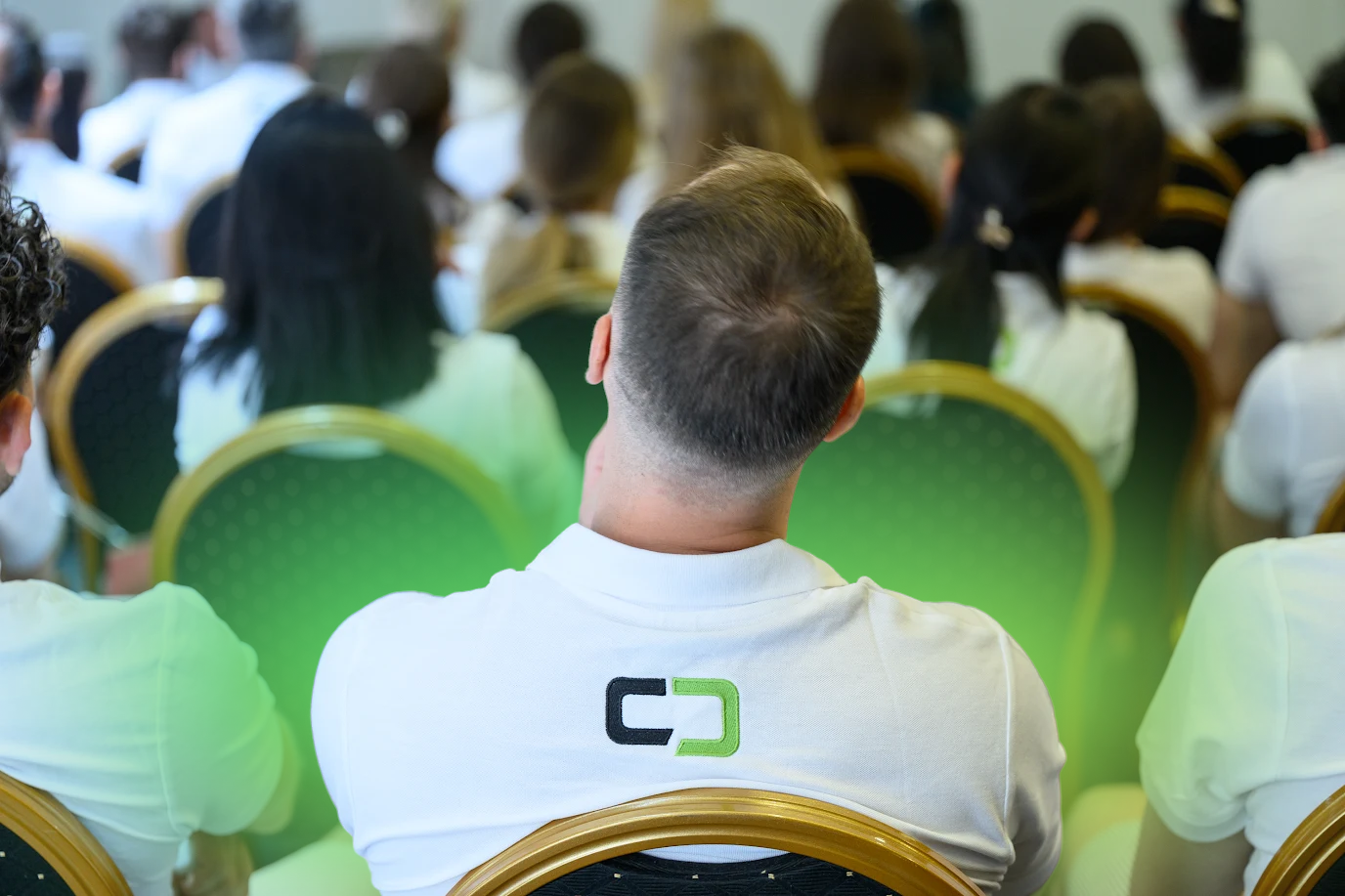 Converst team member attending a presentation during the company team-building event