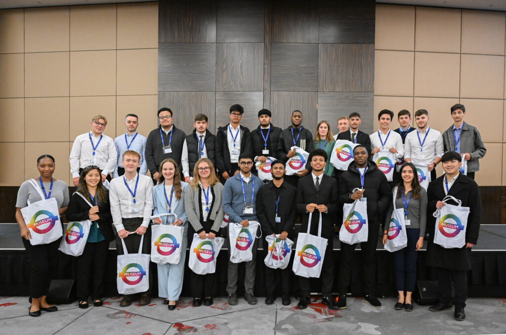 TfL employees smiling and holding TfL signs.