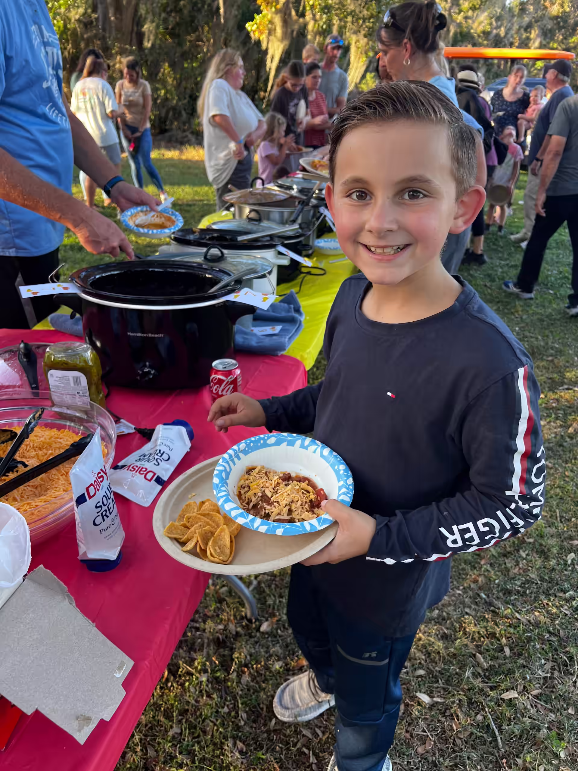 Child holding plate at picnic