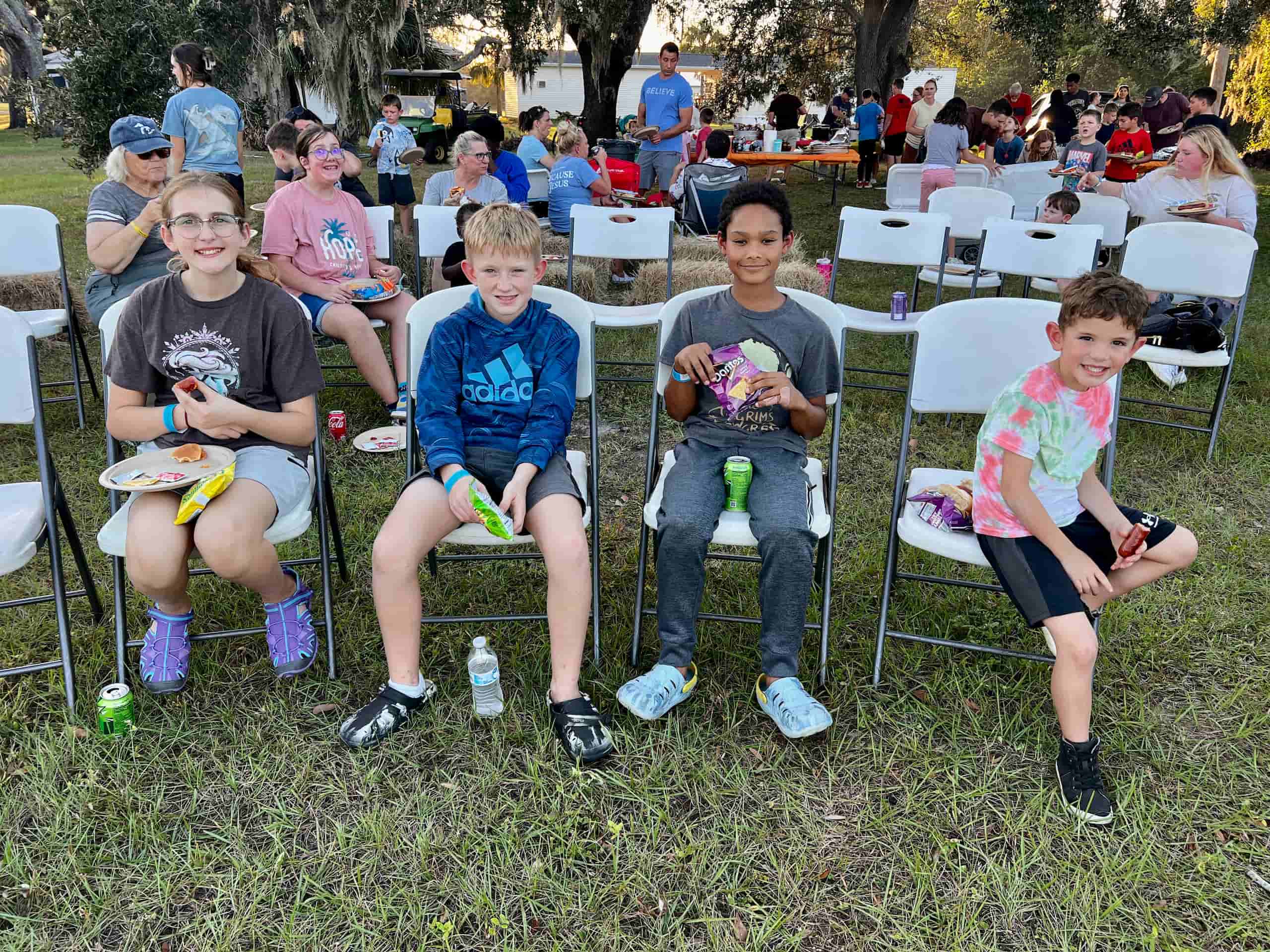 Families and children enjoying a picnic meal