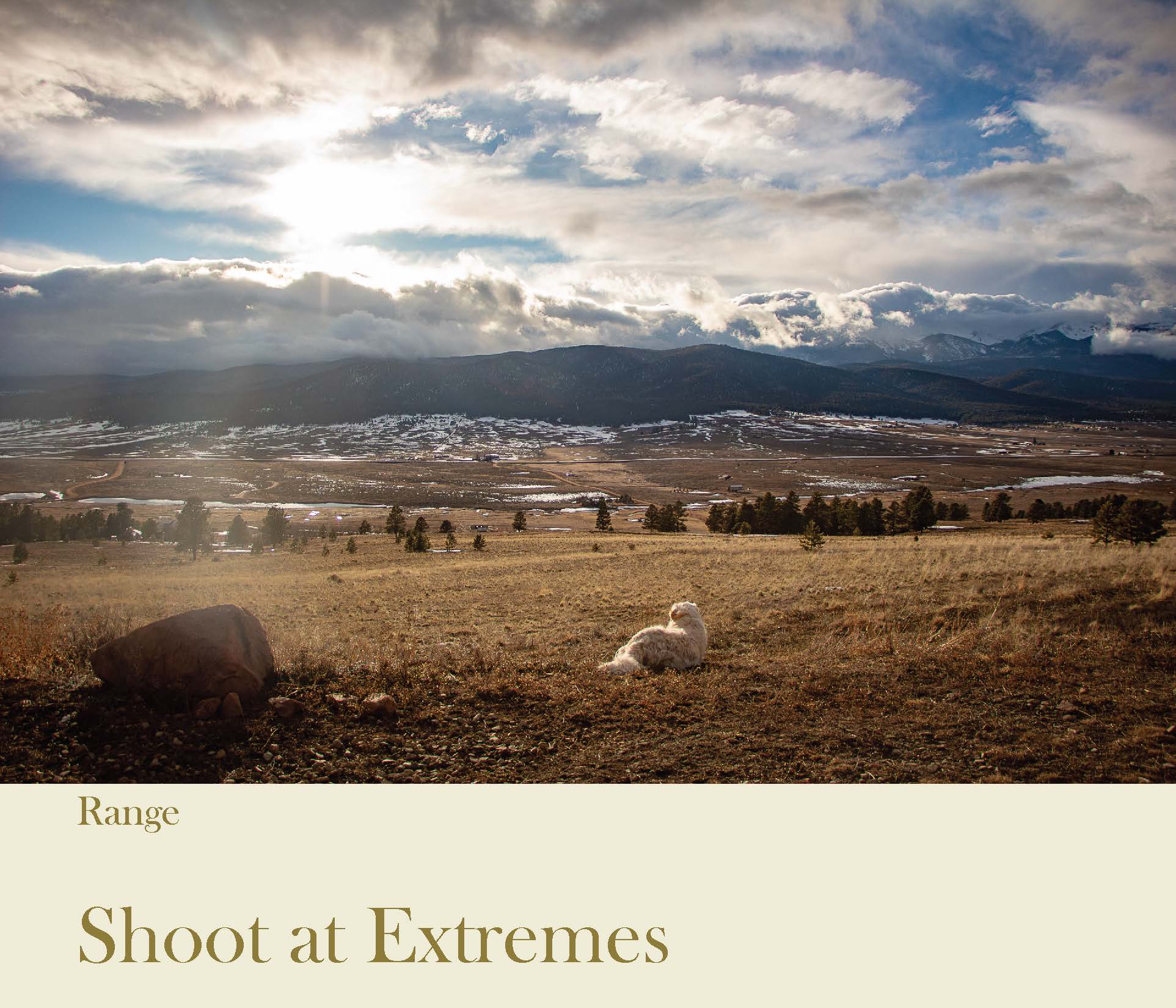 a landscape of mountains with the sun shining over them