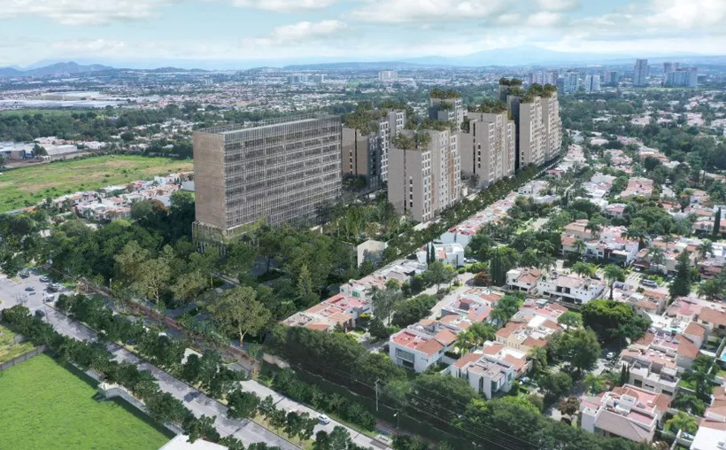 Vista aérea de un complejo residencial con edificios altos y áreas verdes rodeado de casas unifamiliares.