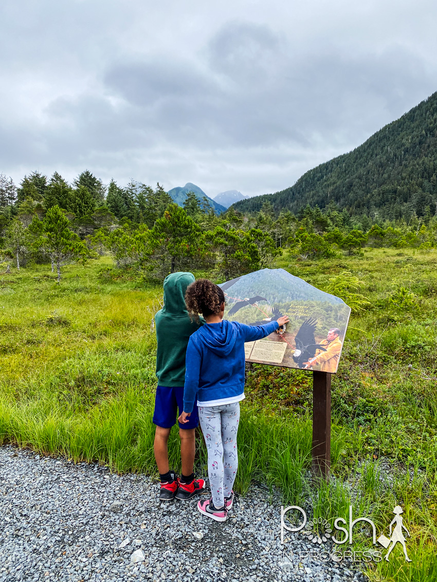 things to do in sitka 2 | Things to do in Sitka Alaska by popular LA travel blog, Posh in Progress: image of a young boy and girl looking at an informational sign at the Alaska Raptor Center.
