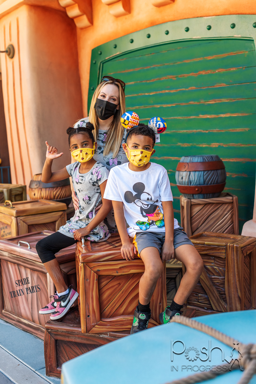  Disneyland Reopening by popular LA lifestyle blog, Posh in Progress: image of a mom and her two kids at the Disneyland Roger Rabbit ride and wearing Mickey Mouse and Minnie Mouse clothing. 