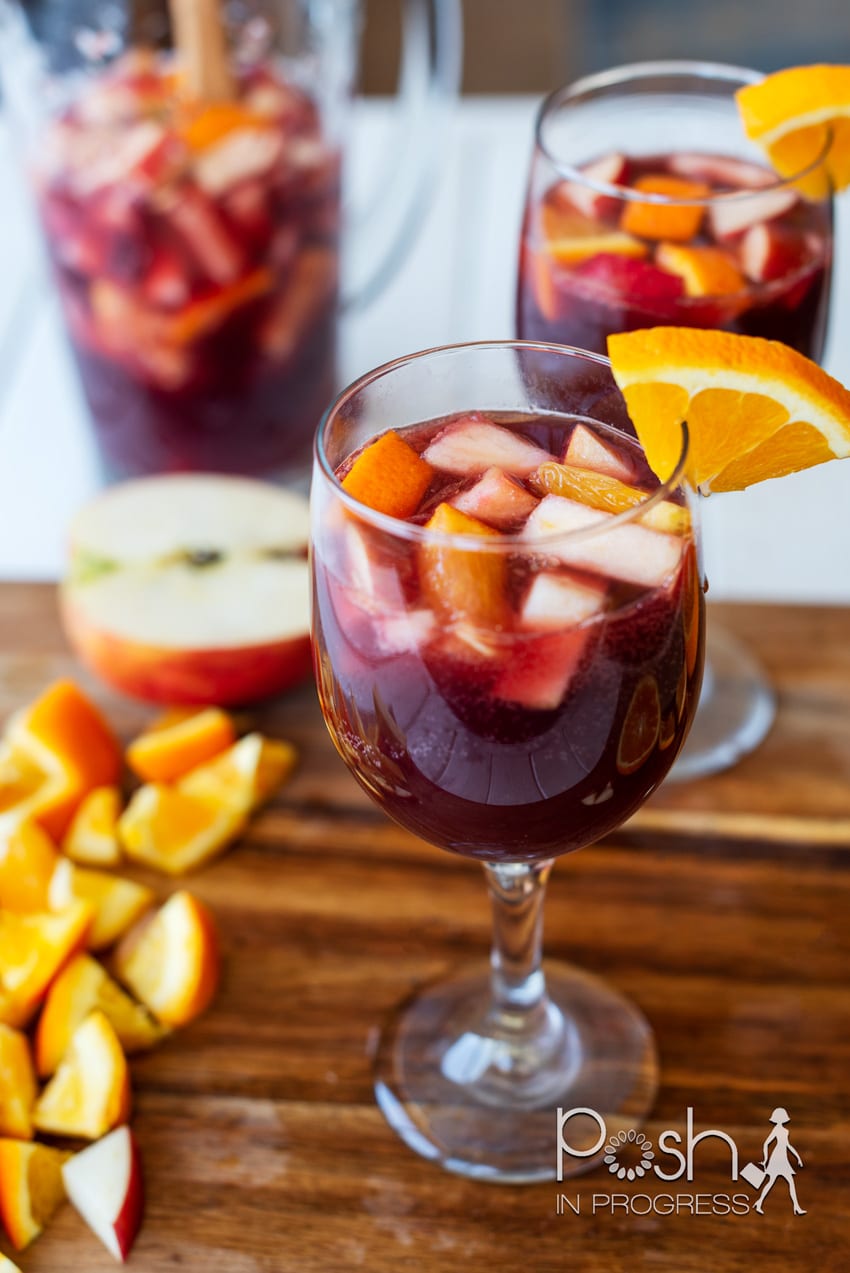 Glass of traditional red sangria with orange and apple slices