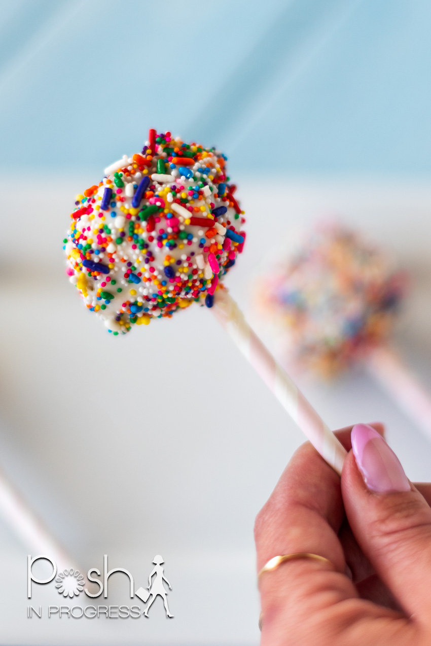 Donut cake pops coated in white chocolate and sprinkles