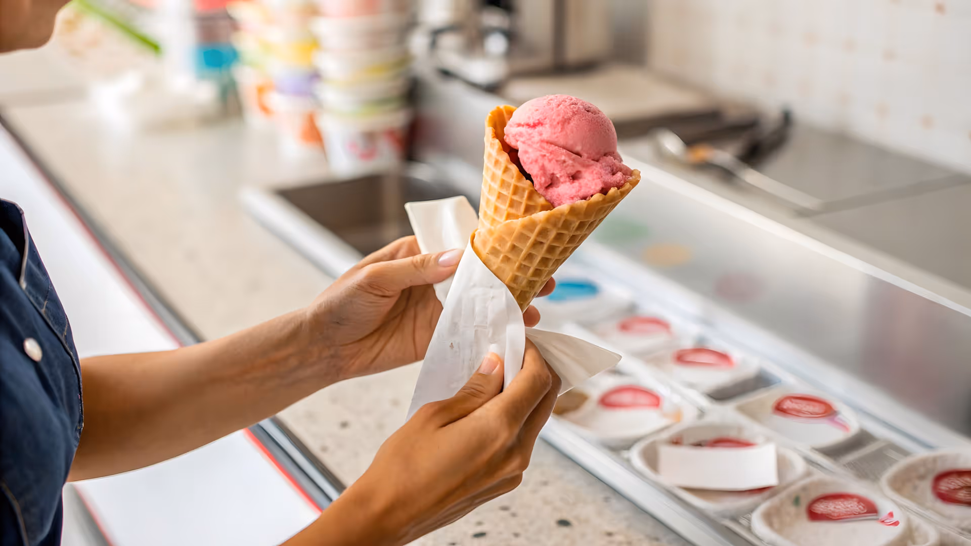 serving a strawberry cone gelato