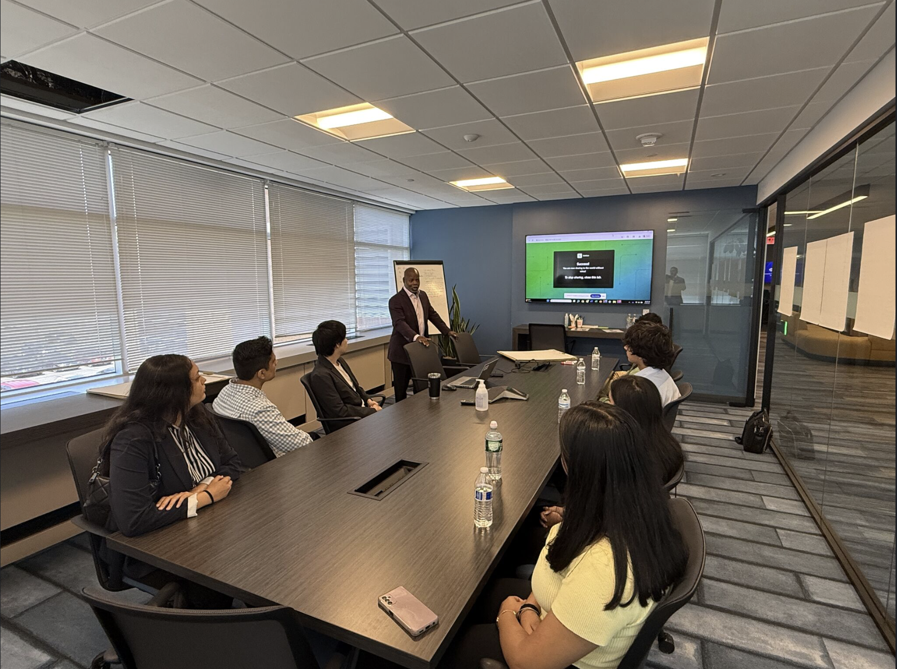 KATBOTZ team members networking at a professional event with vibrant lighting, representing collaboration and connection.