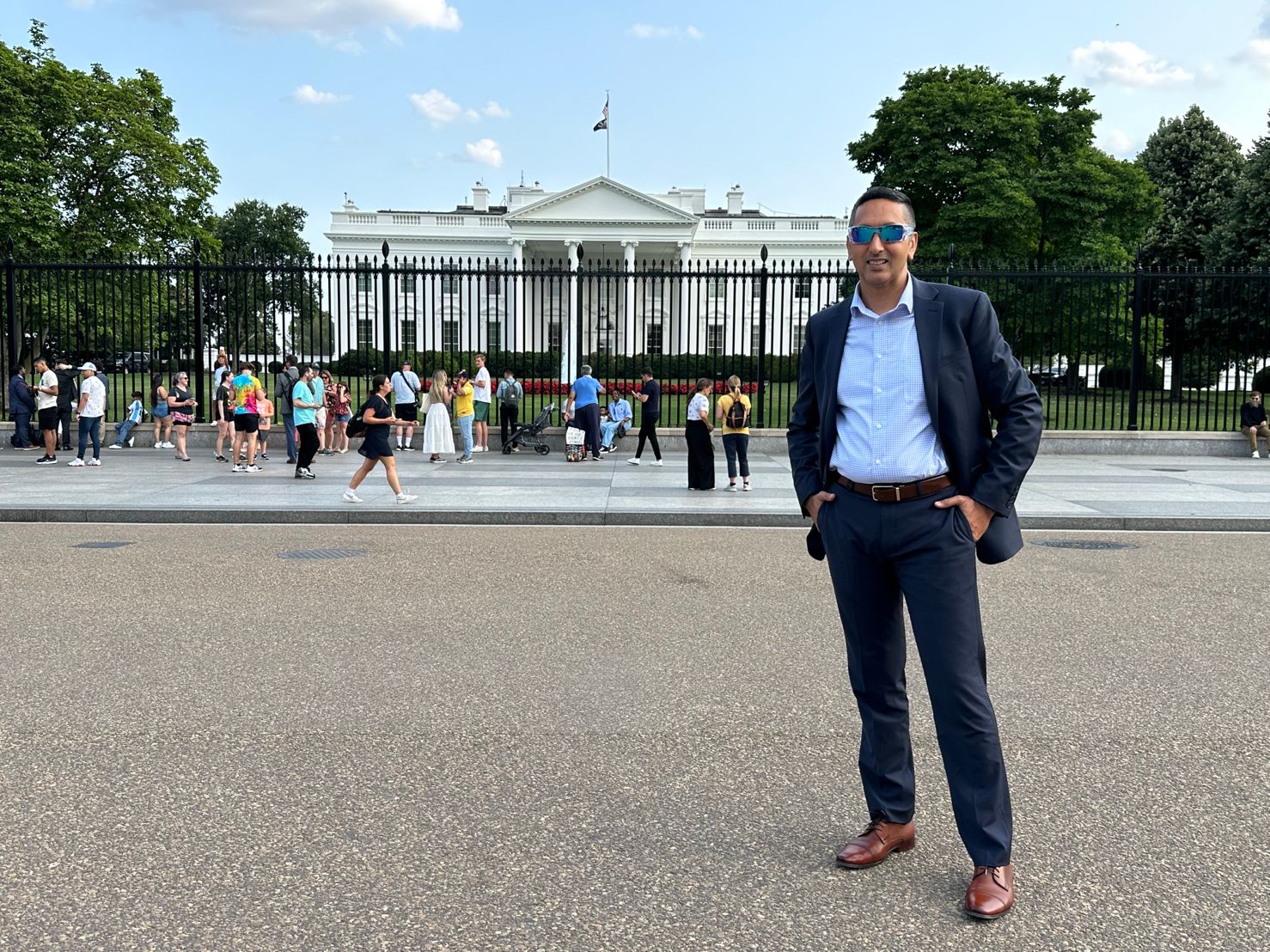 Ashish standing in front of the White House, representing leadership and global perspective.