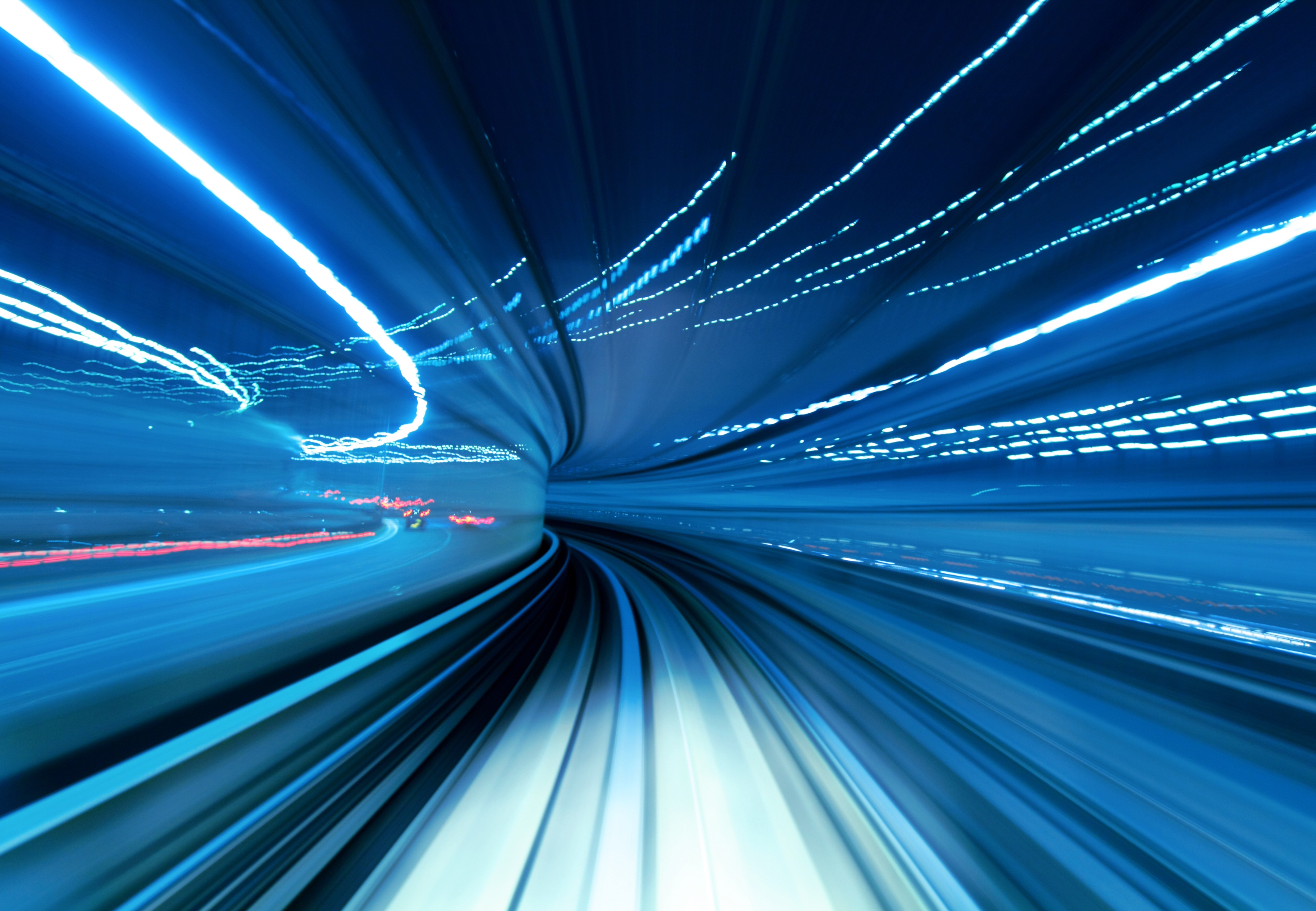 Blue light motion blur in a tunnel, symbolizing speed, efficiency, and streamlined business operations
