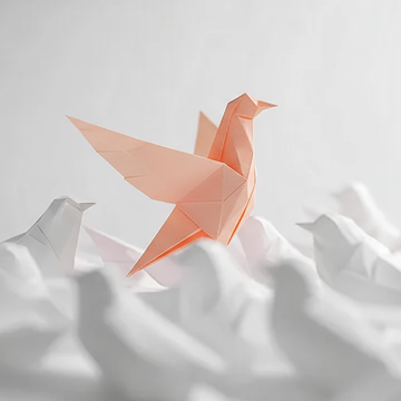 A pink origami bird, resembling a dove or crane, sits on a white, crumpled paper surface, symbolizing the theme "Be your Boldest Self."