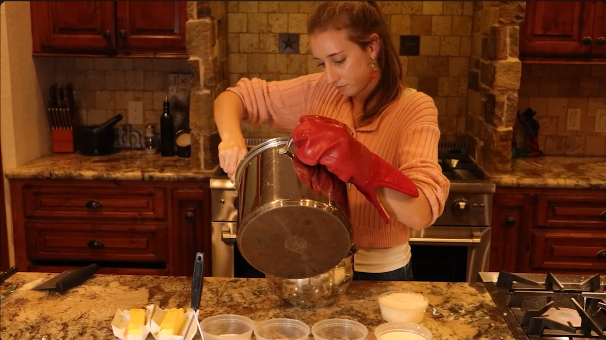 Screenshot of a video made by bryndon, has a girl pouring out a pot of boiling potatoes.