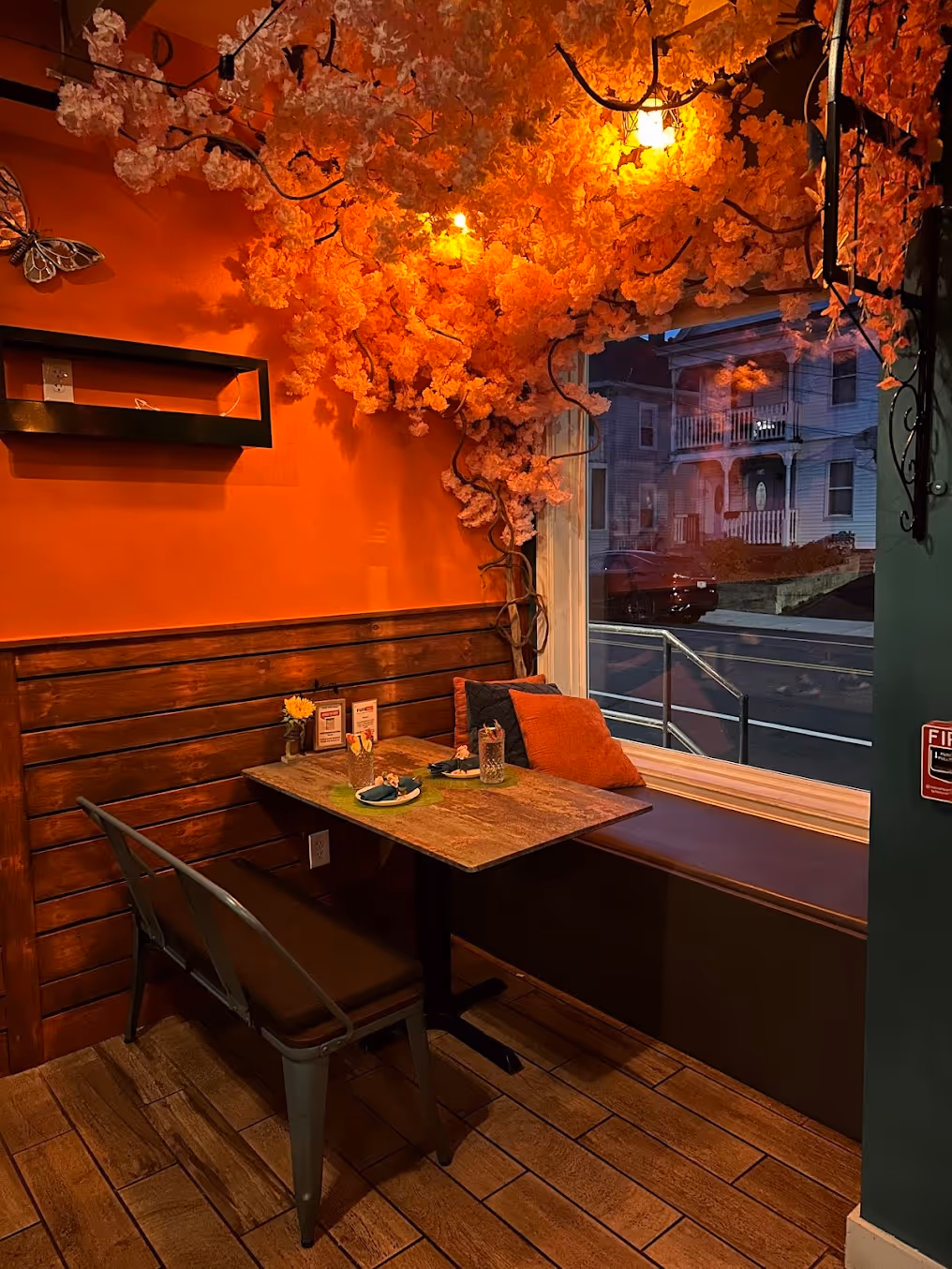 A restaurant with a wooden table and chairs.