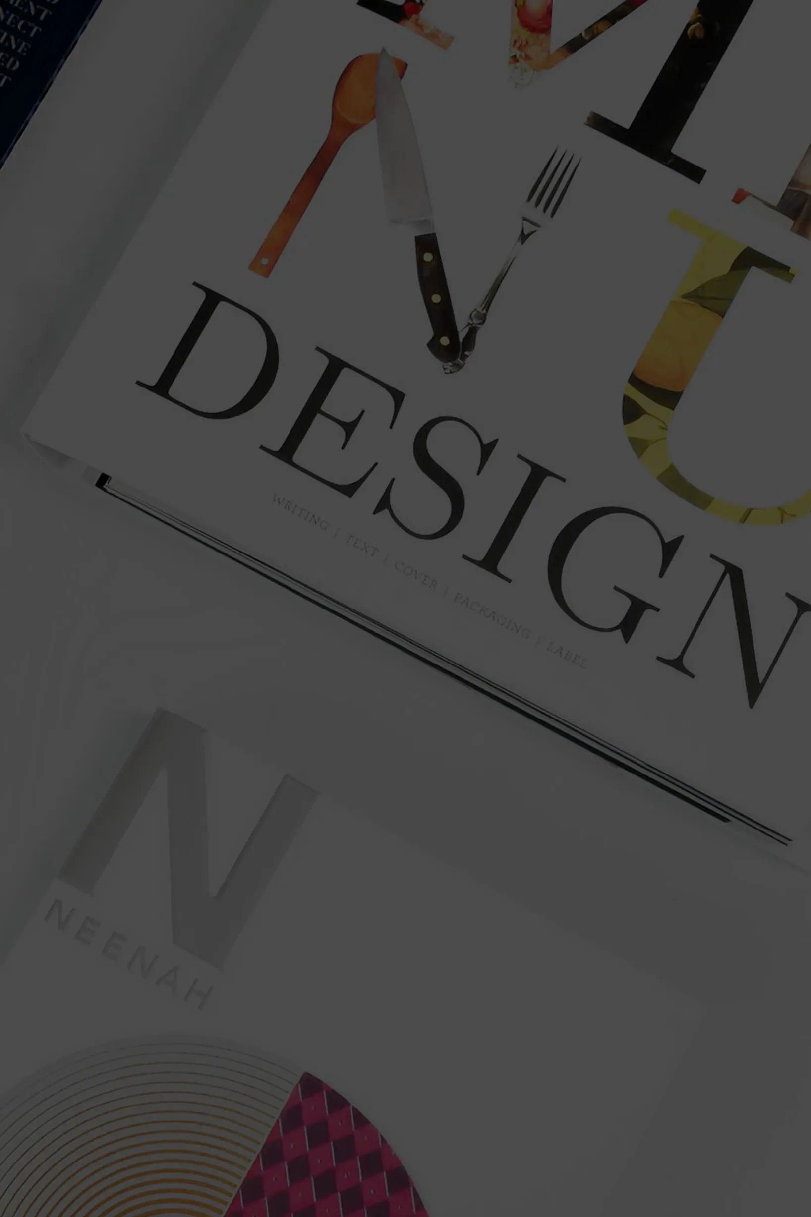 Top view of two stacked design magazines, the top one titled VV Design featuring a spoon, knife, and fork forming the letter V.