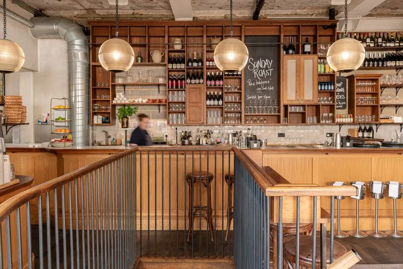 A mouthwatering Sunday roast with Yorkshire puddings, tender roast beef, greens, and cauliflower cheese, topped with rich gravy. One of the best Ambl-recommended spots for a traditional British dining experience.