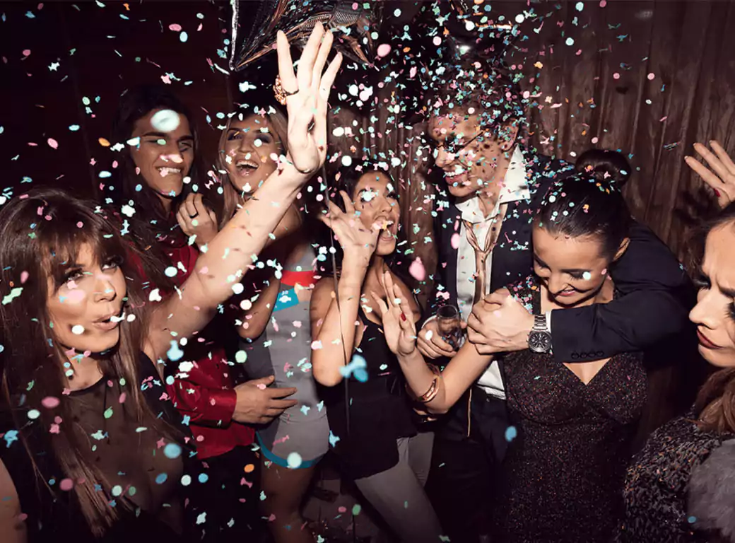 A high-energy club scene with people dancing and celebrating, representing the unforgettable nights out Ambl helps create.