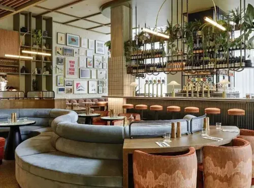 A stylish and modern bar with plush seating, warm lighting, and an inviting atmosphere, perfect for a cosy winter gathering. One of the top venues available for instant booking through the Ambl app.