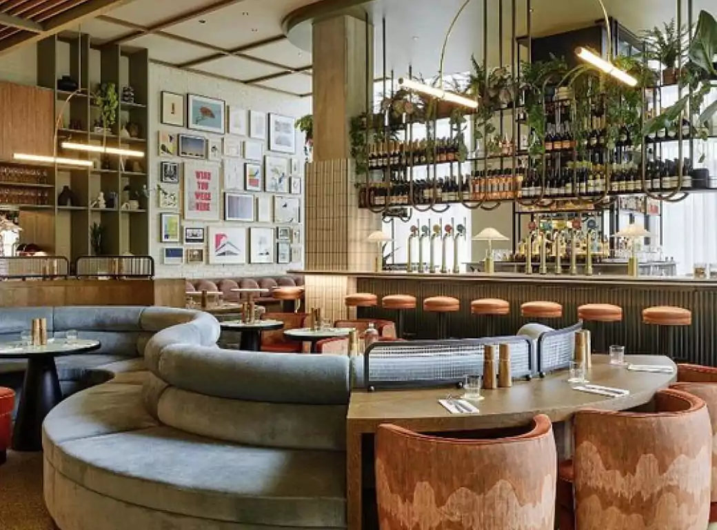 A stylish and modern bar with plush seating, warm lighting, and an inviting atmosphere, perfect for a cosy winter gathering. One of the top venues available for instant booking through the Ambl app.