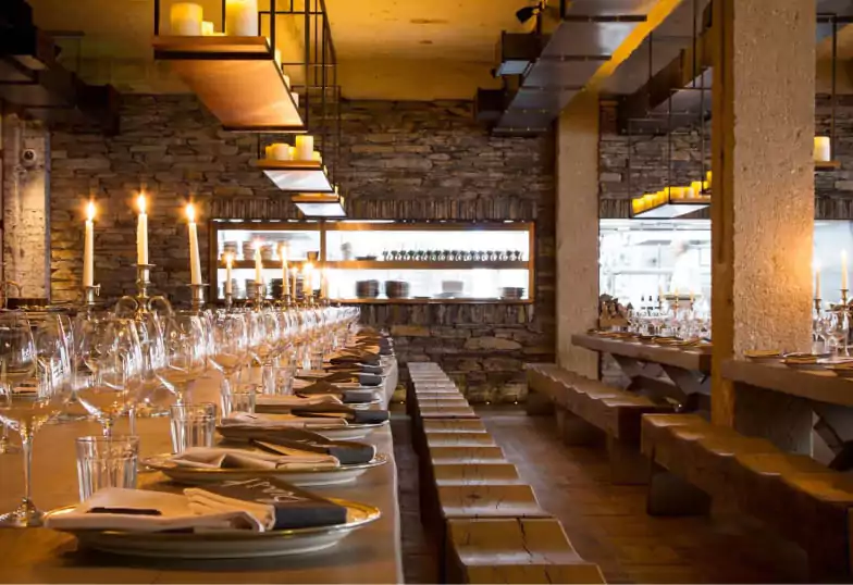 A luxurious seafood platter featuring lobster, scallops, and shellfish, served over a flame at an upscale London restaurant. Find last-minute dining experiences like this with Ambl.