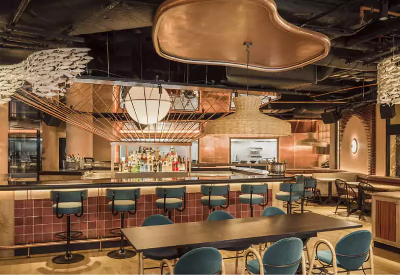 Bibo’s modern Spanish restaurant interior, featuring contemporary décor, a well-stocked bar, and open kitchen vibes. Explore vibrant dining experiences with Ambl.