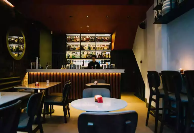 A modern and intimate cocktail bar with a sleek design and warm lighting at Chiave. Find hidden gems like this with Ambl.